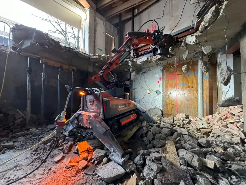 Husqvarna slooprobot die bezig is met het slopen van een verdiepingsvloer